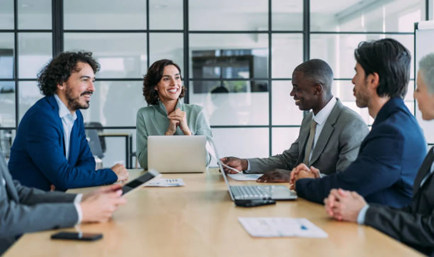 International travel and business professionals meeting around a conference table